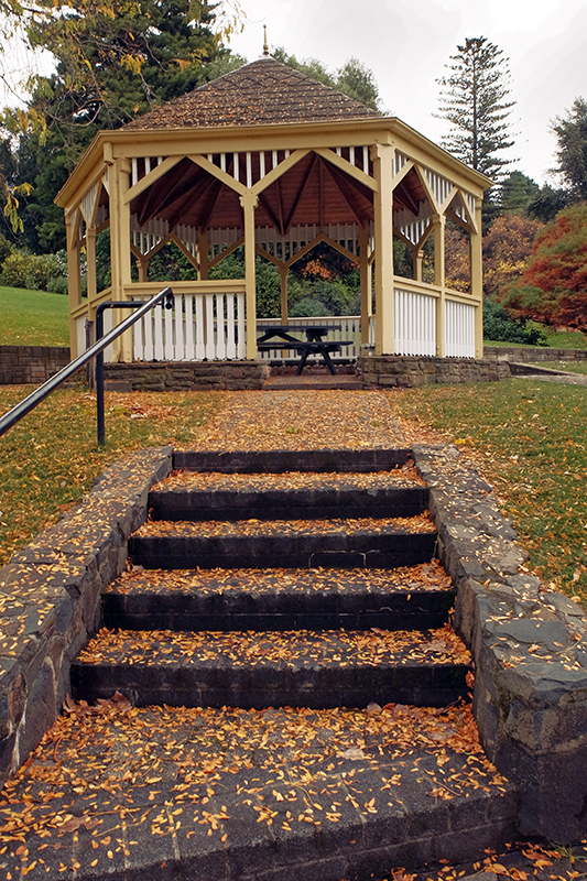 The leaf strewn steps in front of the gazebo.