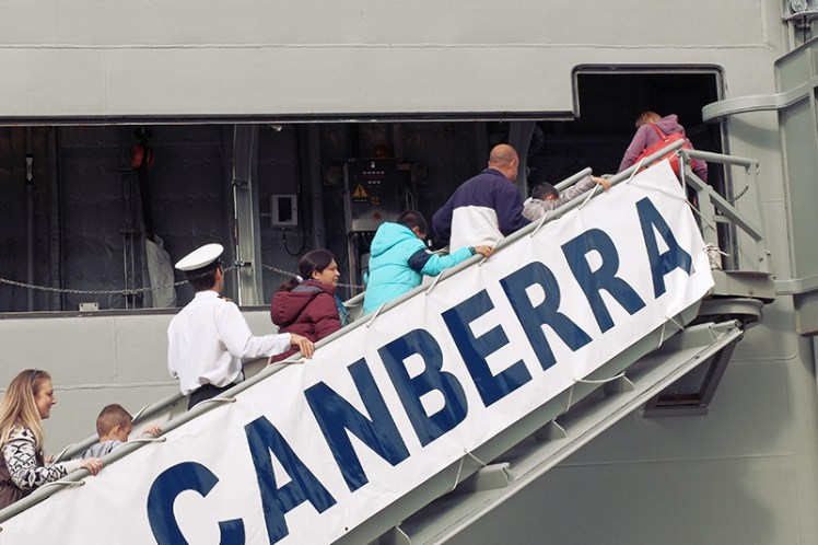 Spot the odd one out. The crew had no special ramp to board the ship so had to shimmy past the crowds.