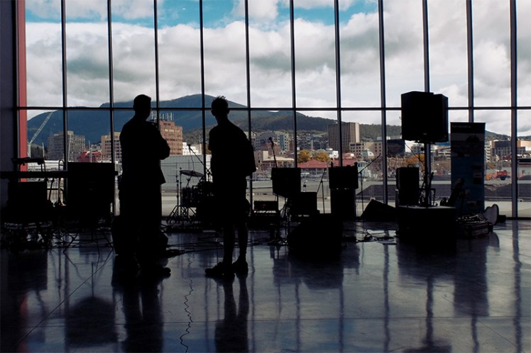 A young musician chats with one of the Navy band members in the cruise-ship terminal overlooking Hobart.