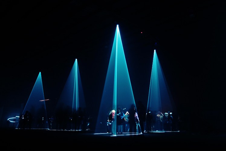 Crowds gather to play with the slowly moving light-show.